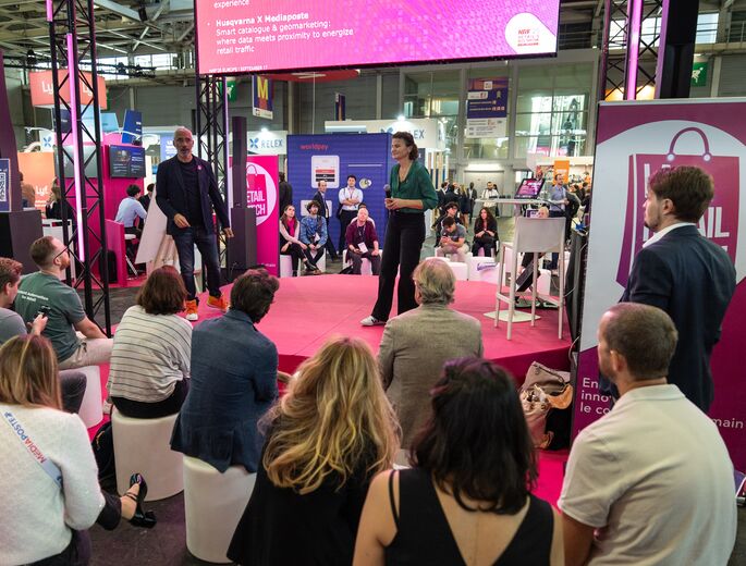 Woman holding a microphone on a pink stage