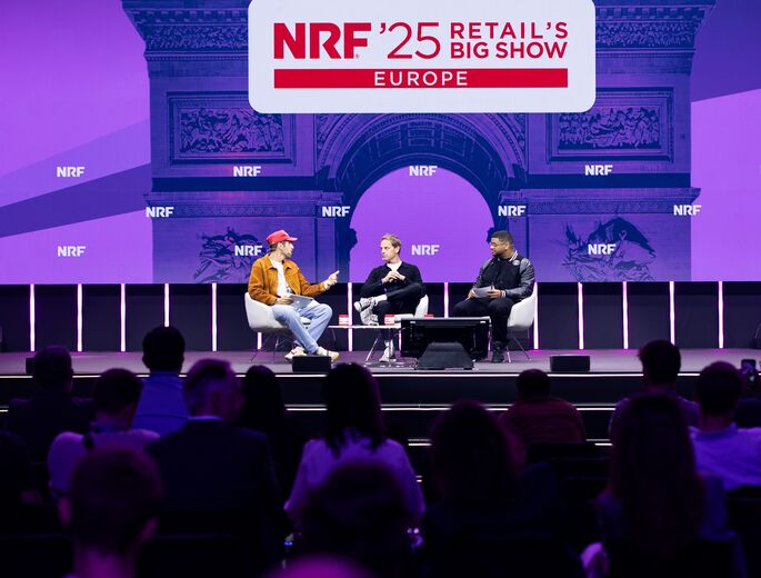 Professionals at a conference in front of a purple screen