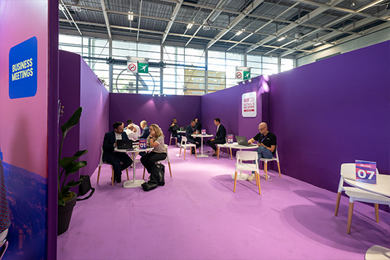 People sitting at tables in the business meeting room