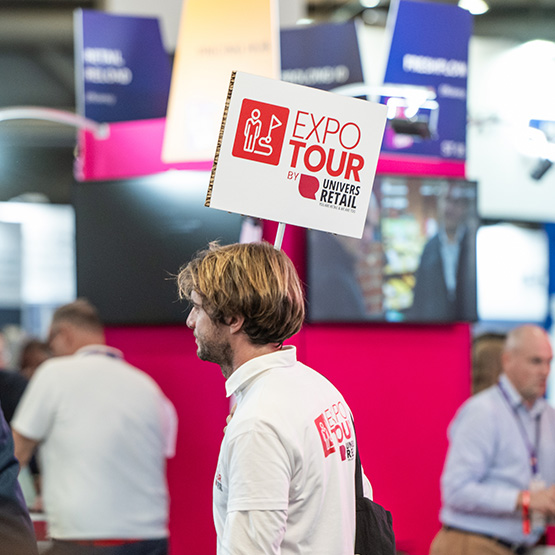 Man holding a sign with the words Expo Tour