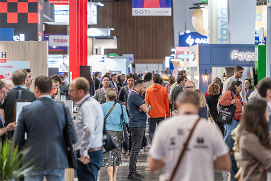 People walking in the aisles of the trade show