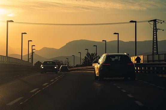 Cars on a road at sunset