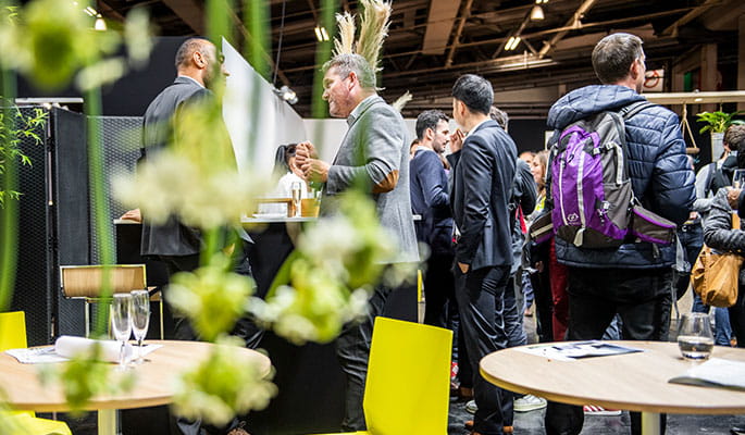 Group of people chatting and networking in a friendly space at the show. 