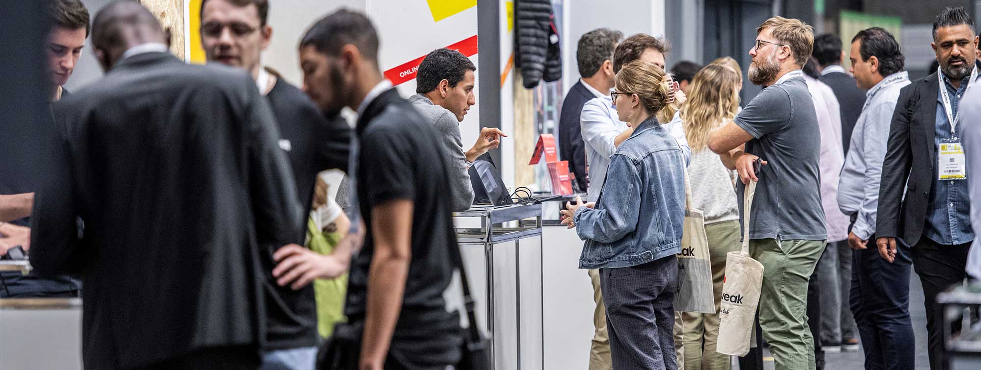 Interactions between visitors and exhibitors at a booth during the show.