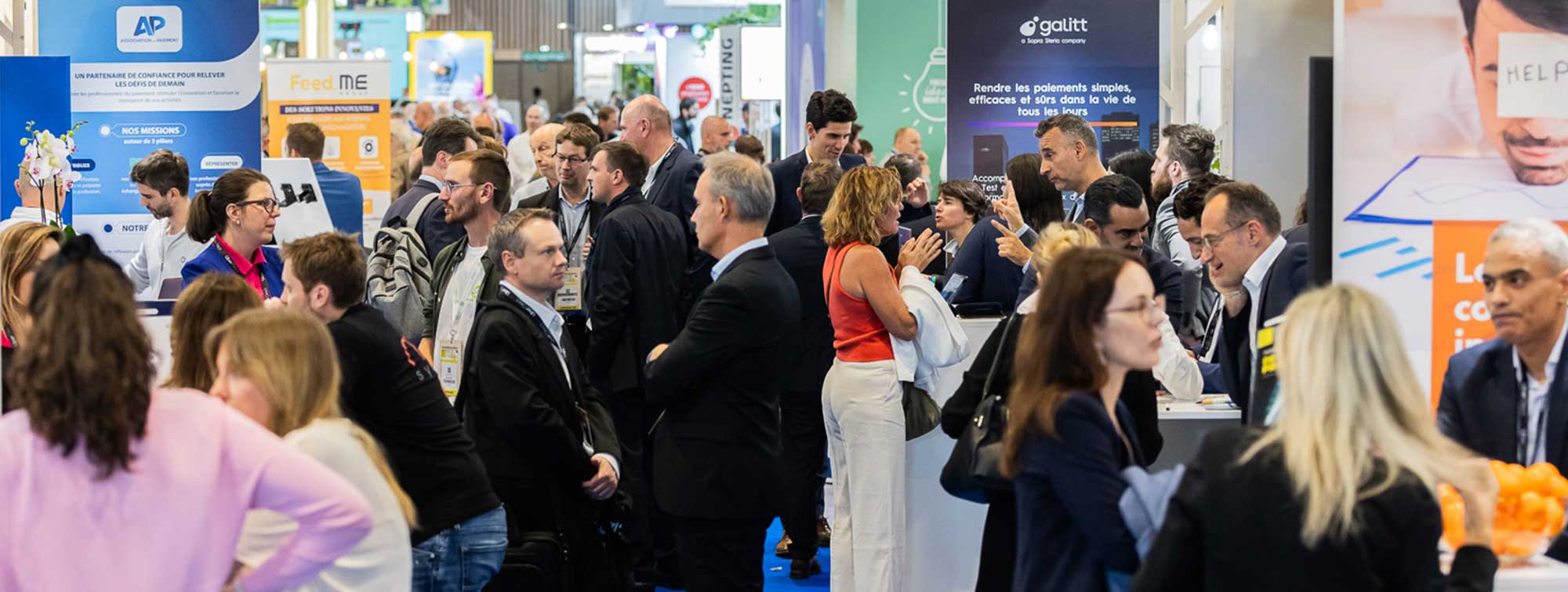 Dynamic view of the aisles of the show, with visitors networking around booths.